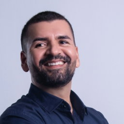 Man in dark blue shirt with arms crossed